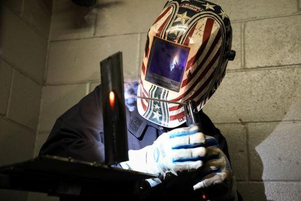 Student welding metal.